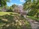 Two story home on a hillside with charming covered porch, garage, and driveway at 322 Peachtree St, Albemarle, NC 28001