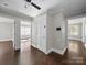 Hallway with hardwood floors, white trim, and neutral paint offers inviting transitions at 322 Peachtree St, Albemarle, NC 28001