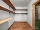 Functional laundry room features wood shelving and flooring, combining convenience and style at 322 Peachtree St, Albemarle, NC 28001