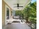 Inviting porch features a cozy swing, ceiling fan, and decorative railing, perfect for relaxing outdoors at 322 Peachtree St, Albemarle, NC 28001