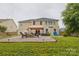 Private backyard with covered area, green grass, and mature trees at 4001 Brook Valley Run, Monroe, NC 28110