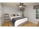 Well-lit bedroom with ceiling fan, wood floors, and decorative pillows at 4001 Brook Valley Run, Monroe, NC 28110