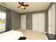 Bedroom features neutral walls, carpet floors, a ceiling fan, and closet with double doors at 4001 Brook Valley Run, Monroe, NC 28110