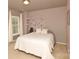 Bedroom with neutral colored walls, carpet, and a decorative tree decal above the bed at 4001 Brook Valley Run, Monroe, NC 28110
