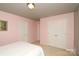 Bedroom featuring pink walls, carpet and a closet with double doors at 4001 Brook Valley Run, Monroe, NC 28110