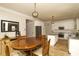 Dining area with hardwood floors is adjacent to a kitchen with stainless appliances and granite counters at 4001 Brook Valley Run, Monroe, NC 28110
