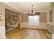 Open concept dining room with wood flooring, stylish lighting, and view into the living room at 4001 Brook Valley Run, Monroe, NC 28110
