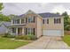 Charming two-story home with a brick and siding facade, manicured lawn and attached two-car garage at 4001 Brook Valley Run, Monroe, NC 28110