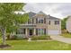 Traditional two-story home with a welcoming front porch, a mix of brick and siding, and a well-maintained lawn at 4001 Brook Valley Run, Monroe, NC 28110
