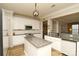 Well-lit kitchen boasts an island, stainless appliances, granite counters and white cabinetry at 4001 Brook Valley Run, Monroe, NC 28110
