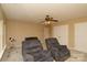 Well-lit living room area features cozy chairs, a ceiling fan, and two windows at 4001 Brook Valley Run, Monroe, NC 28110