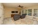 Relaxing living room with neutral colors, two chairs, ceiling fan, and large windows at 4001 Brook Valley Run, Monroe, NC 28110