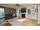Bright living room with a fireplace, large windows, built-in shelving, and a ceiling fan at 4001 Brook Valley Run, Monroe, NC 28110