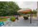 Back patio with covered seating area, chairs, and a green, fenced yard at 4001 Brook Valley Run, Monroe, NC 28110