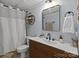 Stylish bathroom featuring a modern vanity, sleek fixtures, and a shower with a white curtain at 4043 Windward Dr, Fort Mill, SC 29708