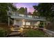 Charming two-story home features a stone facade, a screened porch, and a spacious deck, nestled among mature trees at 4043 Windward Dr, Fort Mill, SC 29708