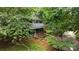 Secluded two-story house surrounded by lush greenery and mature trees at 4043 Windward Dr, Fort Mill, SC 29708