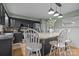 Eat-in kitchen featuring granite counters, stainless appliances, black cabinets, and a breakfast bar with pendant lighting at 4043 Windward Dr, Fort Mill, SC 29708