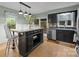 Eat-in kitchen featuring granite counters, stainless appliances, black cabinets, and a breakfast bar with pendant lighting at 4043 Windward Dr, Fort Mill, SC 29708