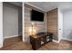 Entertainment space featuring luxury vinyl plank flooring, a decorative wood wall and modern entertainment center at 4043 Windward Dr, Fort Mill, SC 29708