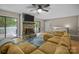 Cozy living room features a stone fireplace, a comfortable sofa, and outdoor access at 4043 Windward Dr, Fort Mill, SC 29708