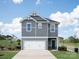 Charming two-story home featuring a two-car garage, complemented by tasteful landscaping at 406 Luna Ln, Shelby, NC 28152