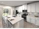Modern kitchen featuring stainless steel appliances, a granite island, and bright white cabinetry at 406 Luna Ln, Shelby, NC 28152