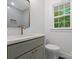Stylish bathroom featuring a modern vanity with a beautiful backsplash and quartz countertop at 4126 Howie Cir, Charlotte, NC 28205