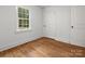 Cozy bedroom with hardwood floors, white walls, and a bright window at 4126 Howie Cir, Charlotte, NC 28205