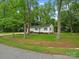 Beautiful home surrounded by lush trees and a well-kept lawn, offering a serene and inviting setting at 4126 Howie Cir, Charlotte, NC 28205
