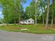 Charming home nestled among mature trees, providing a sense of privacy and natural beauty at 4126 Howie Cir, Charlotte, NC 28205