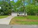 Charming single-story home featuring a two-car garage and a lush, green lawn with mature trees at 4126 Howie Cir, Charlotte, NC 28205