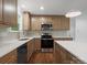 Bright kitchen featuring stainless steel appliances, white countertops, and wooden cabinets at 4126 Howie Cir, Charlotte, NC 28205