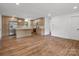 The expansive kitchen features wood floors, an island and stainless steel refrigerator at 4126 Howie Cir, Charlotte, NC 28205