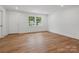 Bright living room featuring refinished wood floors, fresh paint, and updated lighting at 4126 Howie Cir, Charlotte, NC 28205