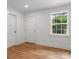 Bright living room featuring refinished wood floors and freshly painted walls at 4126 Howie Cir, Charlotte, NC 28205