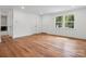 Bright living room features refinished wood floors, fresh paint and updated lighting at 4126 Howie Cir, Charlotte, NC 28205
