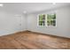 Bright living room featuring refinished wood floors, fresh paint, and updated lighting at 4126 Howie Cir, Charlotte, NC 28205
