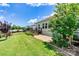 The backyard features green grass, a black metal fence, a stone patio, and a deck at 4197 Canopy Creek Dr, Denver, NC 28037