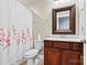 Cozy bathroom with decorative mirror, vanity with sink, toilet, and shower at 4197 Canopy Creek Dr, Denver, NC 28037