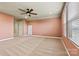 Spacious bedroom with carpet flooring, ceiling fan, and sun-drenched windows illuminating the walls and filling the space with natural light at 4197 Canopy Creek Dr, Denver, NC 28037