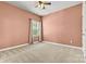 Comfortable bedroom featuring plush carpet, natural light, and ceiling fan at 4197 Canopy Creek Dr, Denver, NC 28037
