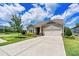 Lovely single-story home with a manicured lawn, mature tree, and inviting two-car garage provides great curb appeal at 4197 Canopy Creek Dr, Denver, NC 28037