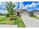 Charming single-story home boasts a well-manicured lawn, mature tree, and an inviting two-car garage at 4197 Canopy Creek Dr, Denver, NC 28037
