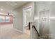 Hallway featuring stairs, chandelier and bathroom with toilet, sink, and shower with view into a bedroom with ceiling fan at 4197 Canopy Creek Dr, Denver, NC 28037