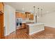 Modern kitchen featuring stainless steel appliances, wooden cabinetry, a stylish backsplash, and a center island at 4197 Canopy Creek Dr, Denver, NC 28037