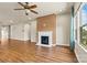 Comfortable living room featuring a cozy fireplace, ample natural light, and stylish ceiling fan at 4197 Canopy Creek Dr, Denver, NC 28037
