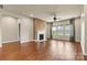 Spacious living room with a fireplace, large windows and a ceiling fan that provides natural light at 4197 Canopy Creek Dr, Denver, NC 28037