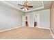 The main bedroom features a tray ceiling, ceiling fan, plush carpet, and ensuite bathroom access at 4197 Canopy Creek Dr, Denver, NC 28037
