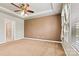 The main bedroom features a tray ceiling, ceiling fan, plush carpet, and ensuite bathroom access at 4197 Canopy Creek Dr, Denver, NC 28037